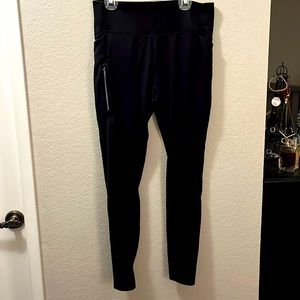 Black All in Motion leggings with pockets and a zipper